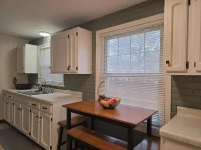 a kitchen with a bowl of fruit on a table at Gather at the Cape in Youngstown