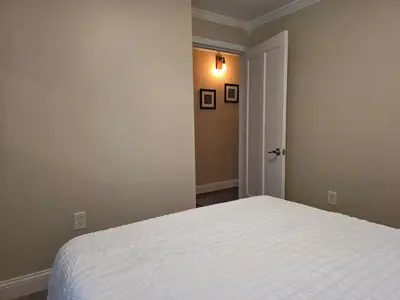 a bedroom with a white bed in a room at Gather at the Cape in Youngstown