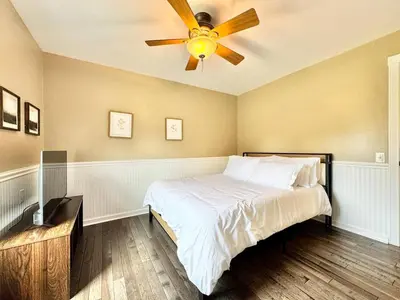 a bedroom with a bed with a ceiling fan at The Porch in Marion