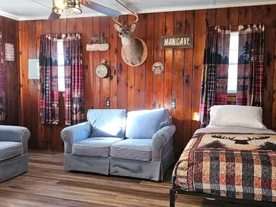 a living room with a couch and a bed at The Huntsmen in Hillsboro