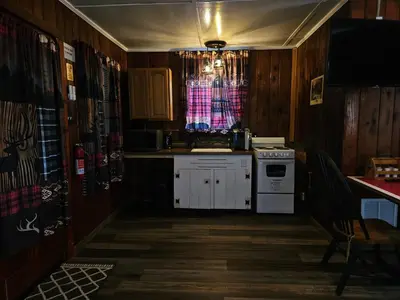 a kitchen with a sink and a stove and a window at The Huntsmen in Hillsboro