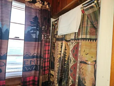 a room with curtains and a window with a windowtaining at The Huntsmen in Hillsboro