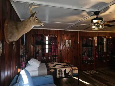 a room with a bed and a deer head on the wall at The Huntsmen in Hillsboro
