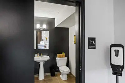 a bathroom with a white toilet and a sink at The 333 Suites 201 - Stay for 6 in Cincinnati