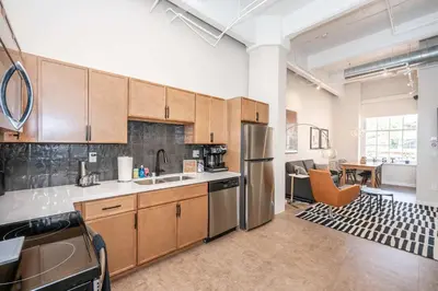 an open kitchen with stainless steel appliances in an apartment at The 333 Suites 202 - Stay for 6 in Cincinnati