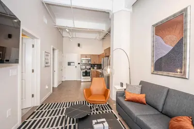 a living room with a couch and a table at The 333 Suites 202 - Stay for 6 in Cincinnati
