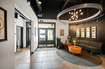 a lobby with a waiting room with a table and chairs at The 333 Suites 202 - Stay for 6 in Cincinnati