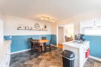 a kitchen with a table and a dining room at The Corner House in Ripley