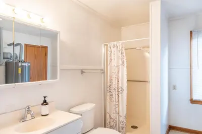 a bathroom with a toilet and a sink and a mirror at The Corner House in Ripley