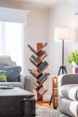 a living room with a book shelf filled with books at The Corner House in Ripley