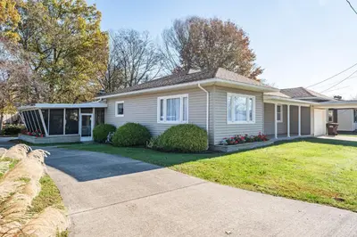 a small house with a yard and a driveway at The Corner House in Ripley
