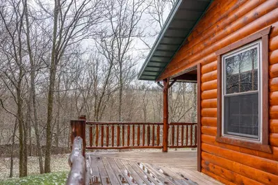 a porch of a wooden cabin with a window at Wildlife Cabin
