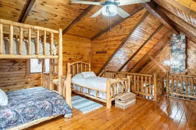 a bedroom with two bunk beds in a log cabin at Wildlife Cabin