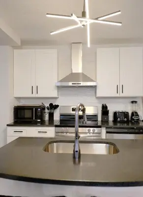 a kitchen with a sink and a ceiling fan at Modern House near OSU and Short North in Columbus