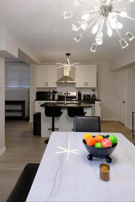 a kitchen with a table with a bowl of fruit on it at Modern House near OSU and Short North in Columbus