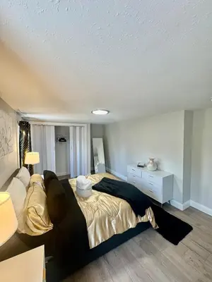 a bedroom with a bed and a white dresser at Modern House near OSU and Short North in Columbus