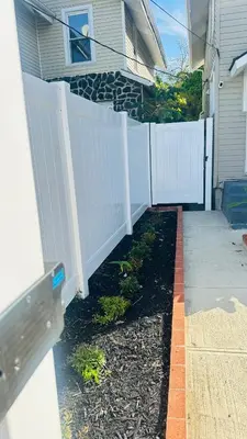 a backyard with a white fence and a driveway at Modern House near OSU and Short North in Columbus