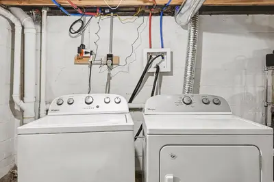 two white appliances in a room with pipes at 2 Bedroom Home - Posh Princeton Pad in Columbus