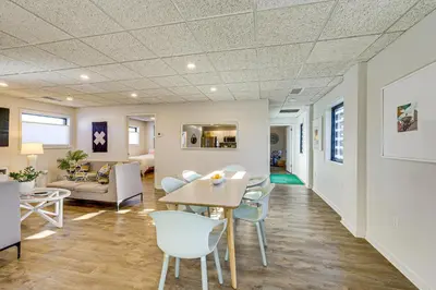 a living room with a table and chairs at Between Restaurant and Brewery! Chic Perrysburg Apt in Perrysburg