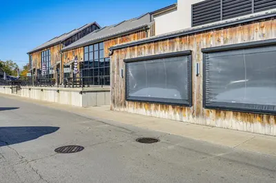 a building with windows on the side of a street at Between Restaurant and Brewery! Chic Perrysburg Apt in Perrysburg