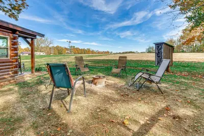 a group of chairs sitting in a yard at Outdoor Oasis with Fire Pit and Dock Galion Log Cabin in Galion