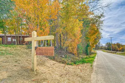 a wooden sign on the side of a road at Outdoor Oasis with Fire Pit and Dock Galion Log Cabin in Galion