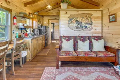 a living room with a couch in a cabin at Outdoor Oasis with Fire Pit and Dock Galion Log Cabin in Galion