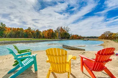 a group of chairs sitting on a beach at Outdoor Oasis with Fire Pit and Dock Galion Log Cabin in Galion
