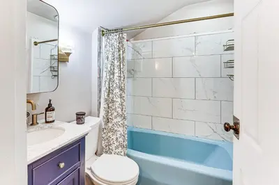 a bathroom with a toilet and a sink and a shower at Cozy Home 4 Mi to YSU Campus Penguins Welcome! in Youngstown