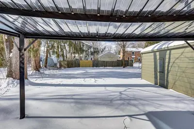 a patio with snow on the ground next to a building at Cozy Home 4 Mi to YSU Campus Penguins Welcome! in Youngstown