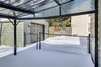 a gate to a garage with snow on the ground at Cozy Home 4 Mi to YSU Campus Penguins Welcome! in Youngstown