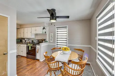 a kitchen and dining room with a table and chairs at Cozy Home 4 Mi to YSU Campus Penguins Welcome! in Youngstown