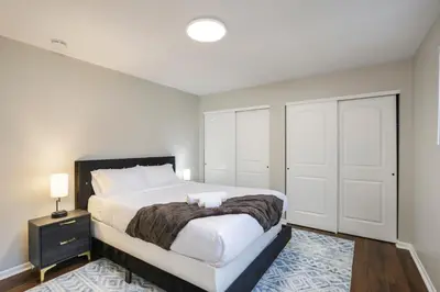 a bedroom with a large bed and a closet at Spacious 4BR Near Botanical Gardens in Columbus