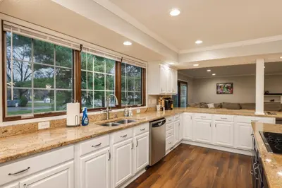 a kitchen with white cabinets and a large window at Spacious 4BR Near Botanical Gardens in Columbus