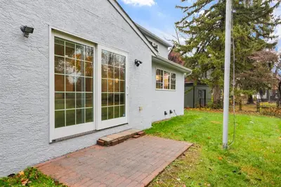 a white house with a brick patio in the yard at Spacious 4BR Near Botanical Gardens in Columbus