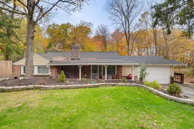 a house with a lawn in front of it at Easy Cleveland Access! Quiet Suburb Stay with Yard in Bedford