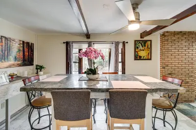 a dining room with a table and chairs at Easy Cleveland Access! Quiet Suburb Stay with Yard in Bedford