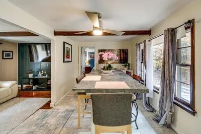 a dining room with a large table and chairs at Easy Cleveland Access! Quiet Suburb Stay with Yard in Bedford