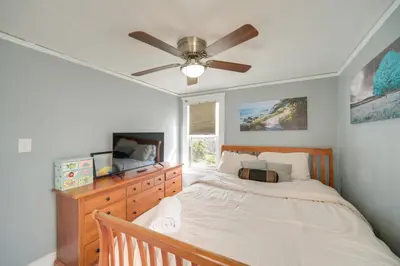 a bedroom with a bed and a ceiling fan at Modern and Convenient! Group Stay in Highland Square in Akron