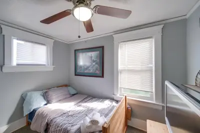 a bedroom with a bed and a ceiling fan at Modern and Convenient! Group Stay in Highland Square in Akron