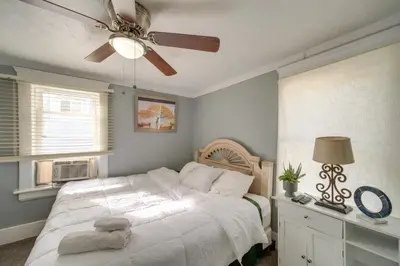a bedroom with a bed and a ceiling fan at Modern and Convenient! Group Stay in Highland Square in Akron