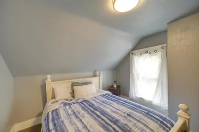a bedroom with a bed and a window at Modern and Convenient! Group Stay in Highland Square in Akron