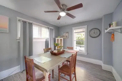 a dining room with a table and a ceiling fan at Modern and Convenient! Group Stay in Highland Square in Akron