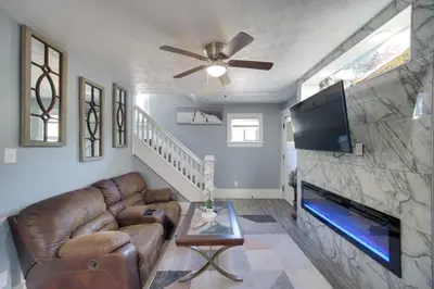 a living room with a couch and a flat screen tv at Modern and Convenient! Group Stay in Highland Square in Akron