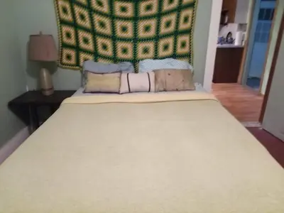 a large bed in a bedroom with a large headboard at Marina house