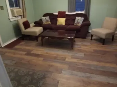 a living room with a couch and two chairs at Marina house