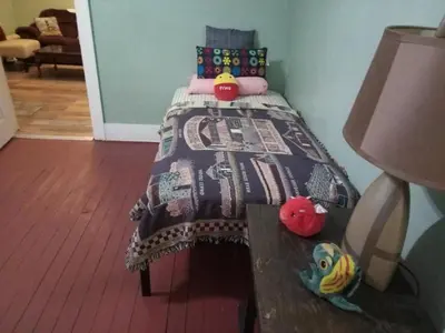 a bedroom with a bed with a quilt on it at Marina house
