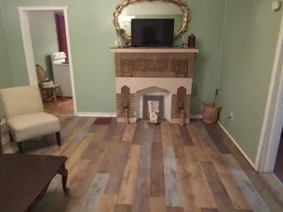 a living room with a fireplace and a tv at Marina house