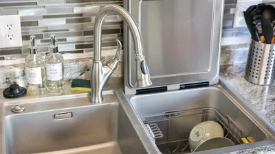 a stainless steel kitchen sink with a faucet at Hearth Home Brick Oven Karaoke 4 Bedroom fits 8 in Columbus