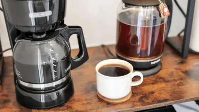 a coffee maker and a cup of coffee on a table at Hearth Home Brick Oven Karaoke 4 Bedroom fits 8 in Columbus